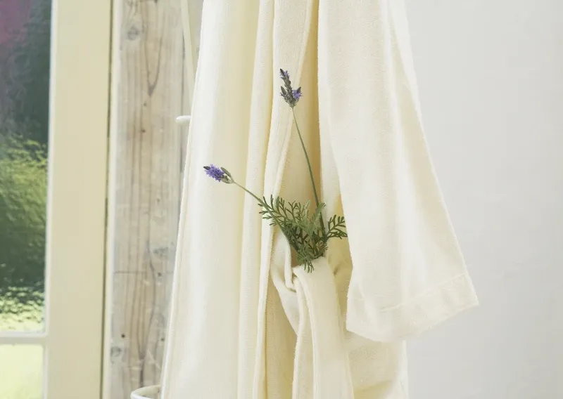 A linen robe with a sprig of lavender